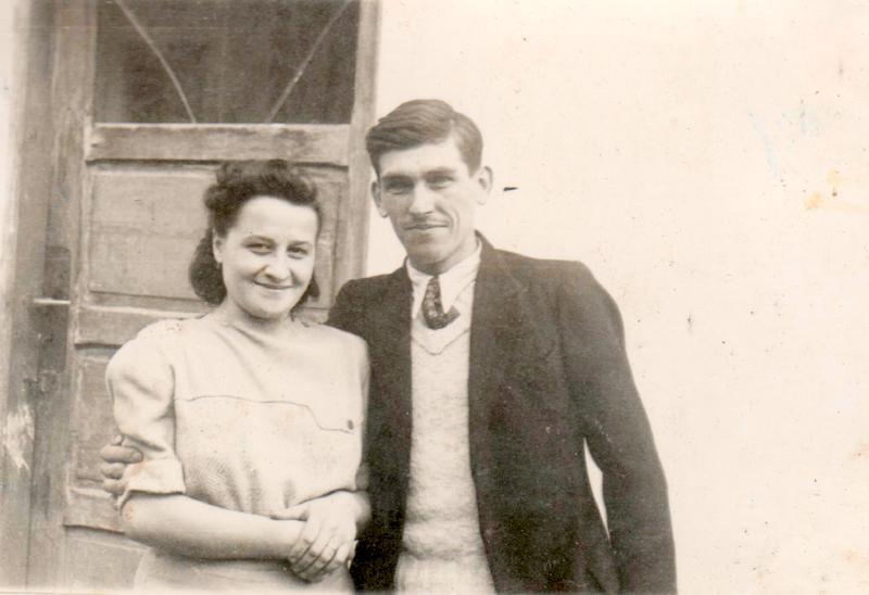 sepia photo of a young man in a tweed jacket, one arm arm around the shoulders of a young woman in a cream-coloured dress; the writer's grandparents