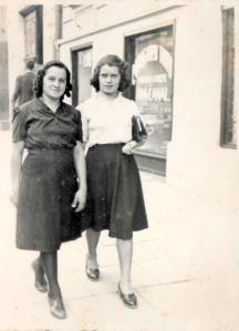 black and white photo of two young women walking down a city street, wearing fashionable 1930s clothes and hairstyles; the writer's grandmother and her grandmother's friend