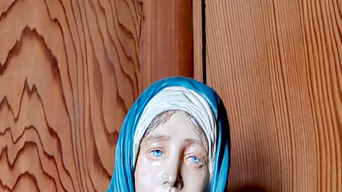 close-up of blue eyes of a Virgin Mary figurine